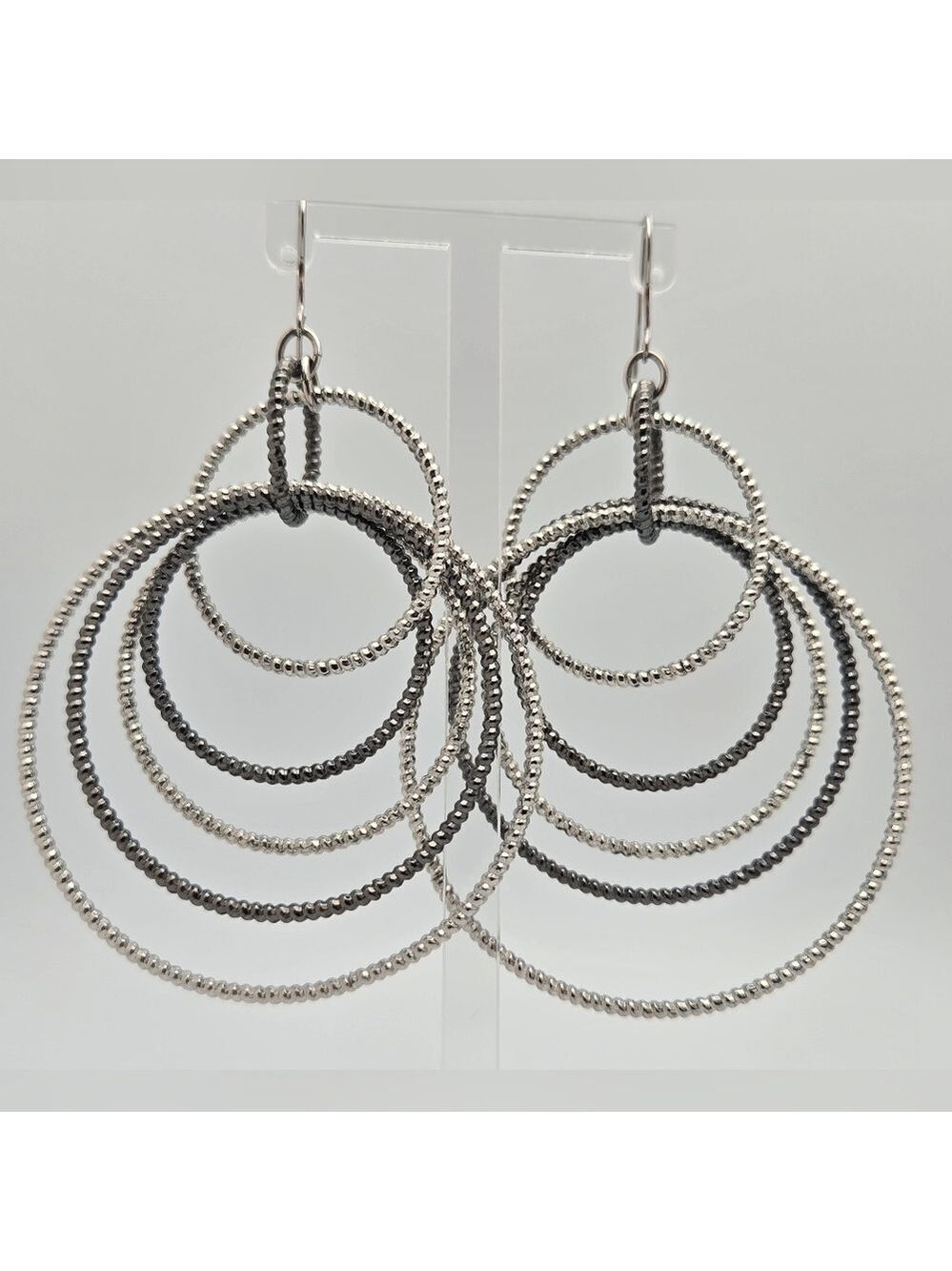 GUESS Silvertone Textured Orbital Wire Linear Drop Hoop Earrings  Statement